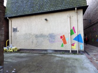 View of graffiti (old and new) on the rear (N) wall of 107/109 High Street, on the E side of the vennel.