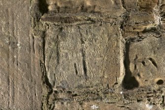 Possible carved fragment set into wall to right of church doorway