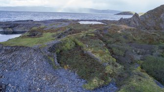 Oblique aerial of south west corner of Easdale Island showing flooded quarries, garden enclosures (pre-1872) and a later post-1899 tramway (centred at NM73549 17046) cutting through the earlier enclosures.