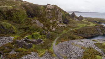 Oblique aerial view of remains of buildings associated with An Toll Mar Luaty and An Lub Chlear quarries> forge (foreground), engine house and boiler house beyond