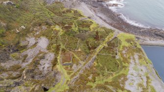 Oblique aerial view of garden enclosures and tramways at the south west part of Easdale Island adjacent to Fang Quarry