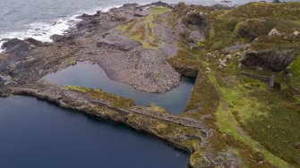 Oblique aerial view from south of An Toll Mar Luaty and An Lub Chlear Quarries as well as the engine house remains