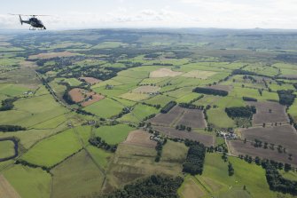 General oblique aerial view of Strathearn and PDG helicopter with a BBC crew on board filming the HES Aerial Survey team at work.