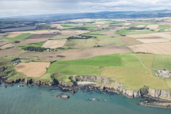 General oblique aerial view of the Aberdeenshire landscape centred on Adam's Castle and Roadside of Kinneff.