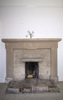 First floor. South east bedroom. Detail of fireplace.