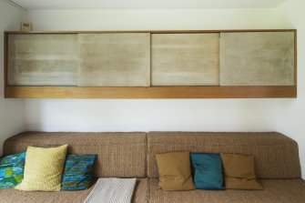 Study. Detail of seating and cupboards.