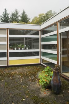 Courtyard. Detail of coloured glazed panels.