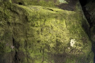 Detail of incised cross and other carvings.