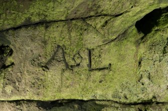 Detail of carved graffiti.