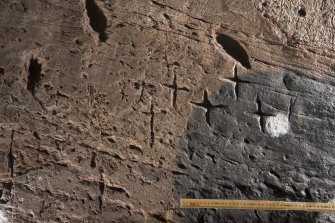 Detail of incised crosses on wall at north side of entrance (including scale)