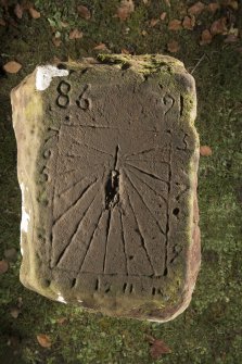 View of sundial on top surface of cross slab