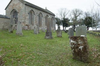 View showing stone in setting of churchyard