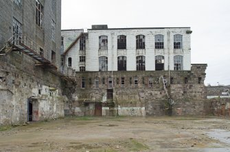 View of rear of building, north end of 1912 mill, now visible as Calender House demolished c. 2017. 