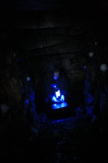 Archaeologist Gemma Hudson preparing equipment for the laser scan survey inside Cracknie souterrain, Tongue