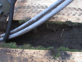 North facing section of trench as it enters lawn area, direction S