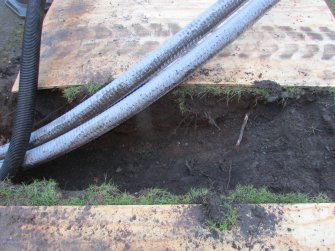 North facing section of trench as it enters lawn area, direction S