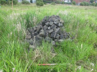 View of pile of setts by site entrance