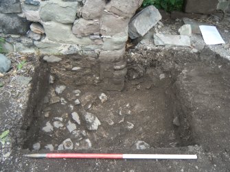 Trench 1. Stone rubble (002) exposed after removal of dumped soil (001), direction N
