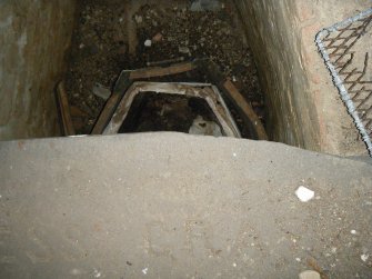 W end of lead coffin within burial crypt, direction W