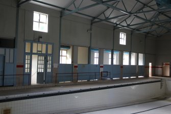 View of swimming pool changing rooms  and entrance, direction facing S