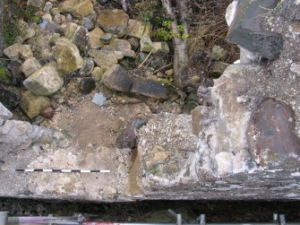 damaged area of wall from above (standing to west), pan S to N 1/2, facing E