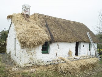 General view  from south showing thatched roof restoration.