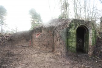 NE facing shot of Ice house inner structure and section of soil mound