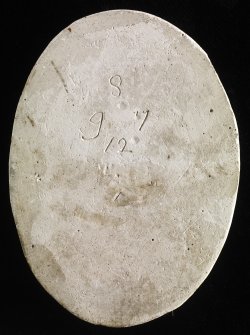 Verso of plaster cast intaglio of a man's head inscribed '8 9 7 12'.