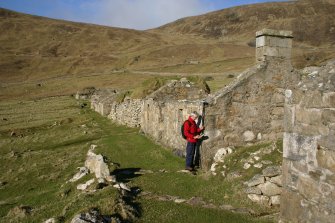 Ian Parker (RCAHMS) surveying House 13.