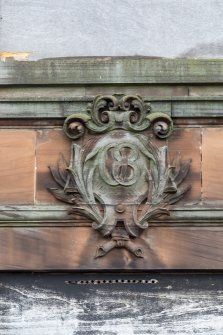 Detail of carved numeric plaque on south face.