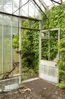 Detail of doorway, mechanisms and floor grill in easternmost section of greenhouse, Walled Garden, Housedale, Dunecht House.