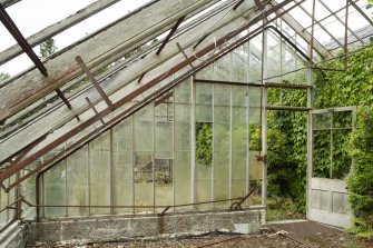 General view of glass dividing wall, doorway, mechanisms and floor grill in easternmost section of greenhouse, Walled Garden, Housedale, Dunecht House.