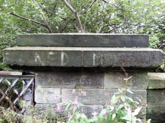 Graffiti on the stone parapet at the south end of east side of the bridge.