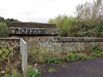 Graffiti on the stone parapet at the north end of west side of the bridge.