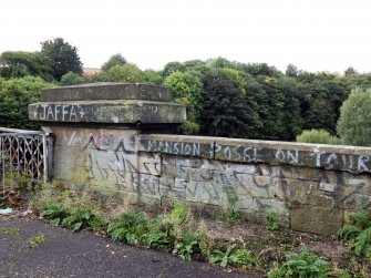 Graffiti on the stone parapet at the north end of west side of the bridge.