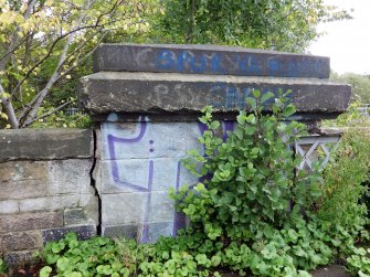 Graffiti on the stone parapet at the north end of east side of the bridge.