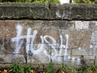 An example of graffiti on the stone parapet of the bridge.