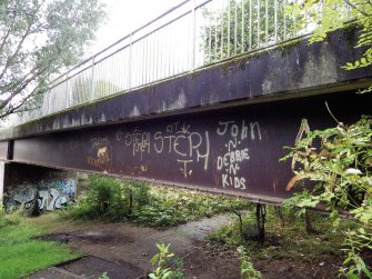 A view of some of the graffiti on the steel beam supports of the footbridge.