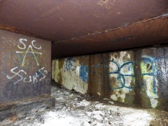 Image illustrating the poor condition of the graffiti written on the damp surfaces underneath the bridge.