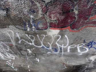 View of graffiti written on the underside of the bridge.