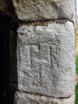 An example of the incised graffiti visible on the door surround at the south end of the building.