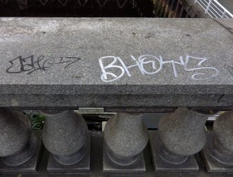 Graffiti on the west parapet of the bridge at its N end.