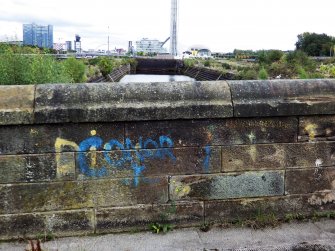 Example of graffiti on the wall to the east of the main access road to the docks.