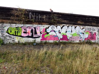 Graffiti on the inner face of the boundary wall on the west side of the dock area.