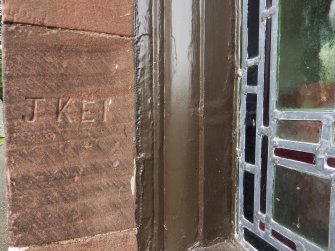 Graffiti incised into a window surround on the south side of the church.