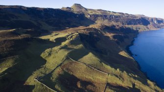 Oblique aerial view showing township and later sheep fank at Hallaig.