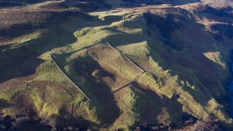 Oblique aerial view centred on the sheep fank and shepherd's house at Hallaig.