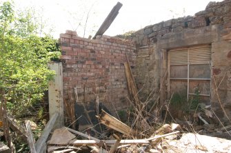 Building 1 carriage house interior, brick-built partitions