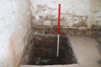 Historic building recording, Room 7, Detail of test pit in NW corner from S, 24-26 West Harbour Road, Edinburgh