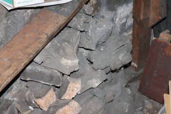 Historic building recording, Room -1/1, Detail of pile of decorative stonework in the basement area along the SE wall from S, Elgin South Parish Church, Moray Street, Elgin